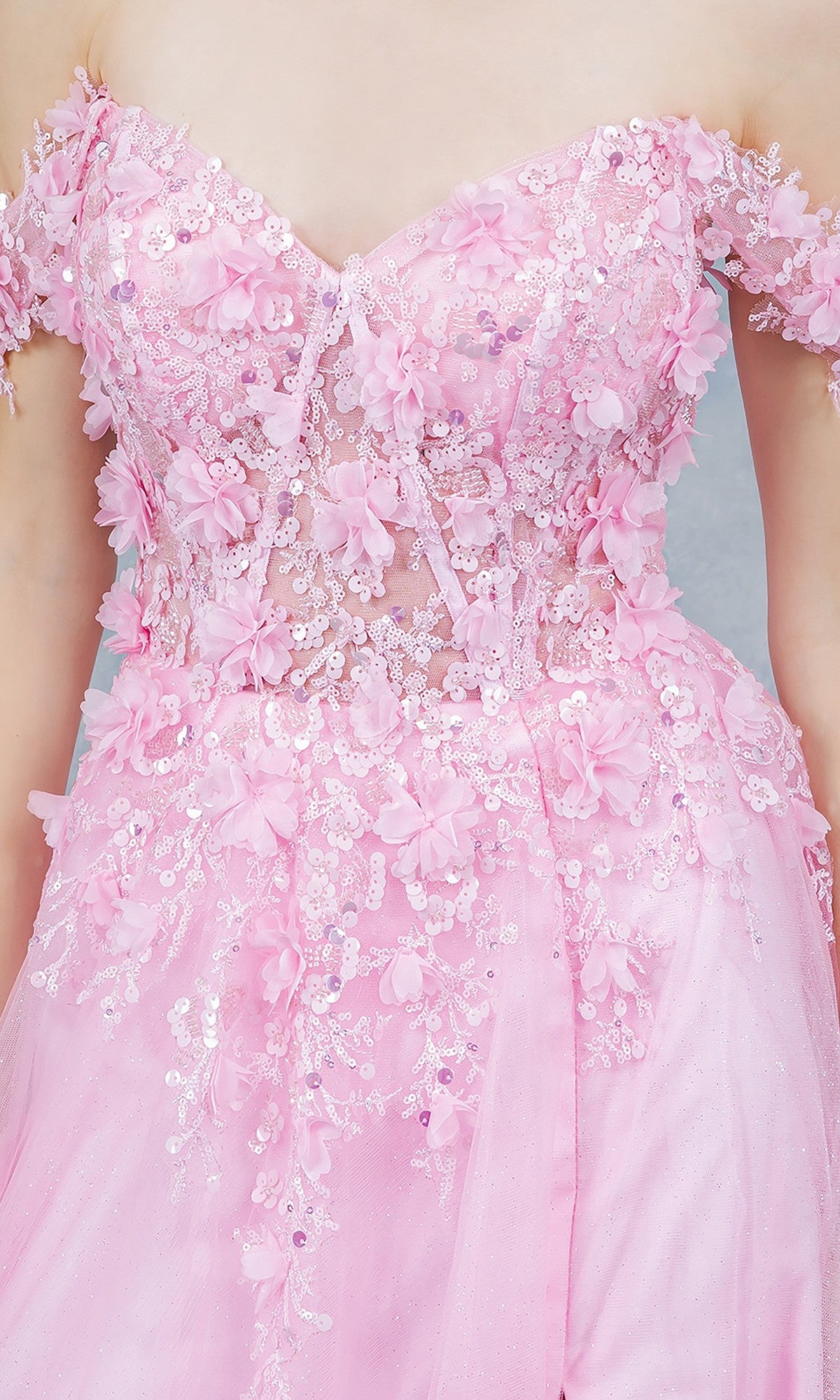 Close-up of a person wearing the Cinderella Couture 8403J long prom dress in pink, featuring off-the-shoulder design with 3D floral appliqués, lace, and sequins for a dreamy look.